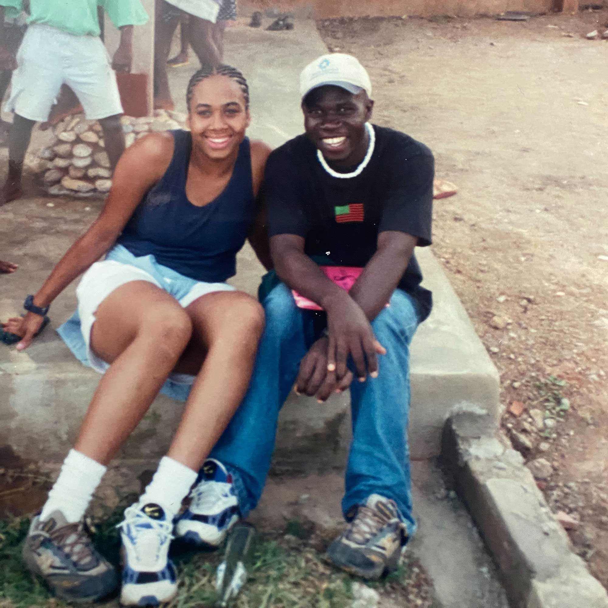 Image of Mickeeya with a friend in Ghana with swapped shoes on.